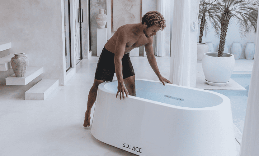 Solace Ice Bath installed in a modern home gym, showing a user preparing for a cold plunge.