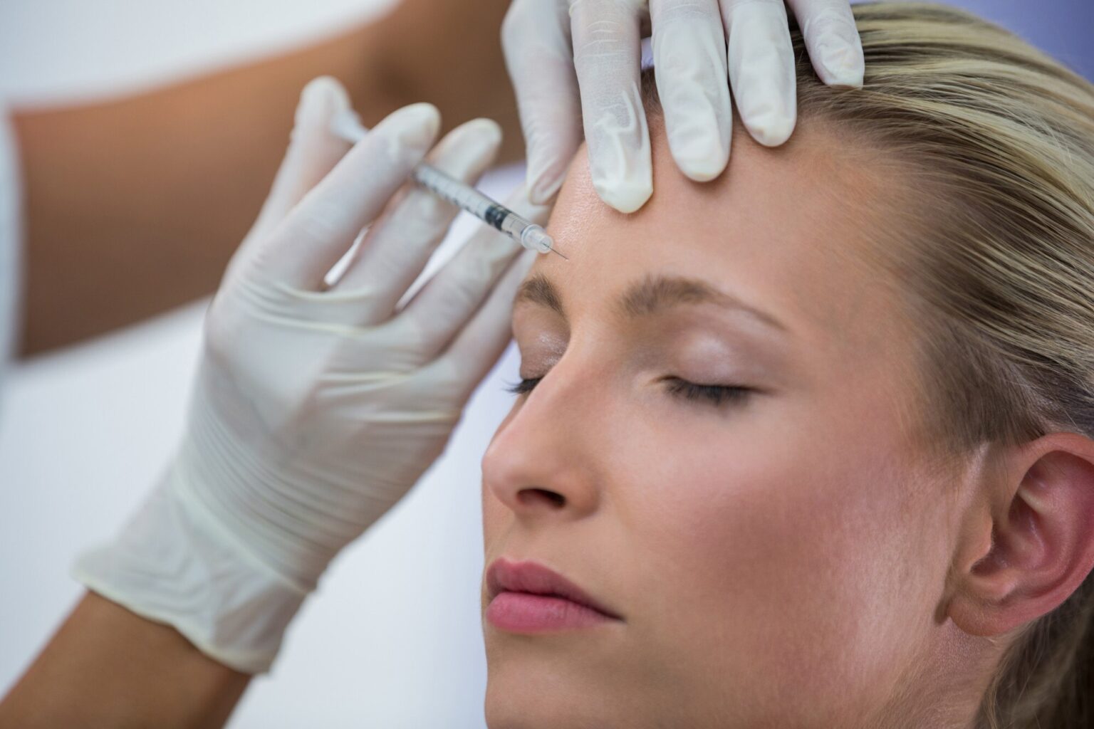 Woman with natural skin receiving injection